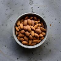 AI generated From Above Ceramic Bowl with Organic Almonds on Concrete Surface For Social Media Post Size photo