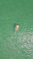 Woman swimming on her back in the crystal clear turquoise sea. video