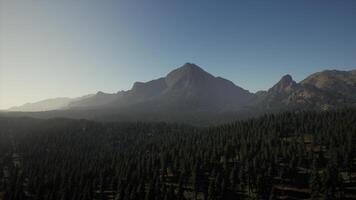 A view of a mountain range with trees in the foreground video