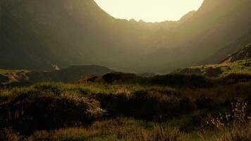 The sun shines through the mountains on a sunny day video