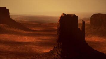 A large rock formation in the middle of a desert video