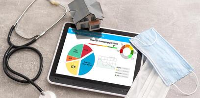 Strategy of diversified investment. Investor managing portfolio. Pie chart and candlestick charts. photo