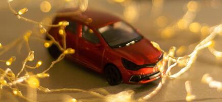 Miniature Car on colorful bokeh background. Holiday Merry Christmas concept. photo
