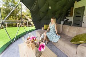 Pretty young caucasian woman resting in glamping outside city. Relaxation concept photo