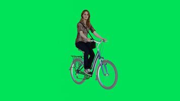 A woman riding a bicycle from a three cornered angle video