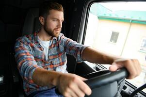 Close up of truck driver behind steering wheel. Copy space. photo