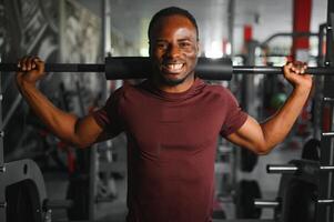 Young athletic African American man in the gym photo