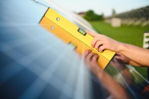 Worker installing solar panels outdoors. photo