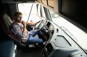 Close up of truck driver behind steering wheel. Copy space. photo