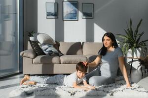 Closeup of happy family playing over the bed in a relaxed morning. Weekend family leisure time concept. photo