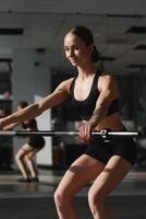 beautiful woman is doing exercises with sports stick photo