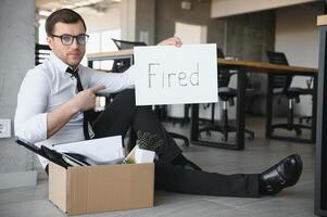 fired employee holding fired sign in hand photo