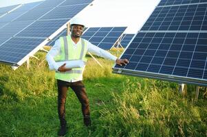 African american technician check the maintenance of the solar panels. Black man engineer at solar station. photo