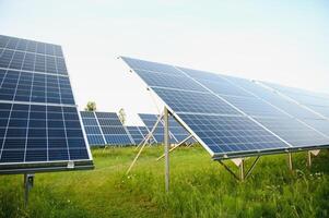 Solar panels energy farm on sky background. photo