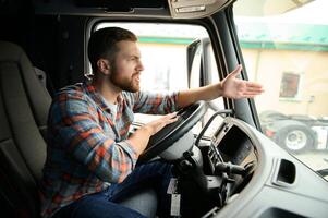 driver behind the wheel in truck cabin photo