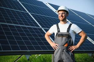 Worker installing solar panels outdoors. photo