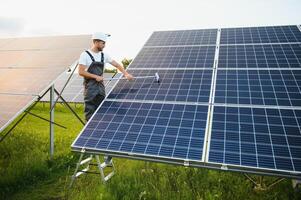 Worker installing solar panels outdoors. photo