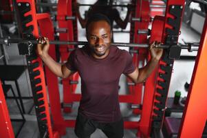 Handsome young African American man working out at the gym photo