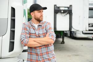 Portrait of trucker standing by his truck ready for driving. Driver occupation. Transportation services photo