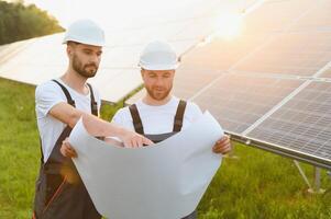 Project manager discuss with worker installation process of solar panel photo