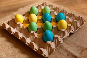 Paint eggs for Easter, bright Easter holiday, children paint eggs, colored eggs in a basket, colored eggs on a stand, Holiday background photo