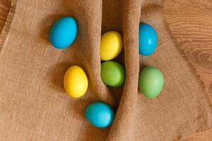 Paint eggs for Easter, bright Easter holiday, children paint eggs, colored eggs in a basket, colored eggs on a stand, Holiday background photo