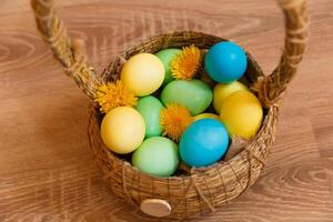 Paint eggs for Easter, bright Easter holiday, children paint eggs, colored eggs in a basket, colored eggs on a stand, Holiday background photo