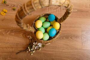 Paint eggs for Easter, bright Easter holiday, children paint eggs, colored eggs in a basket, colored eggs on a stand, Holiday background photo