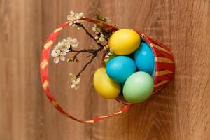 Paint eggs for Easter, bright Easter holiday, children paint eggs, colored eggs in a basket, colored eggs on a stand, Holiday background photo