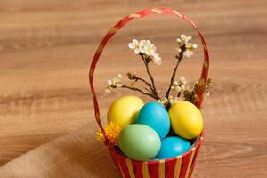 Paint eggs for Easter, bright Easter holiday, children paint eggs, colored eggs in a basket, colored eggs on a stand, Holiday background photo