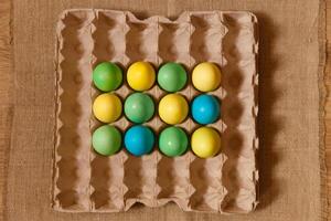 Paint eggs for Easter, bright Easter holiday, children paint eggs, colored eggs in a basket, colored eggs on a stand, Holiday background photo