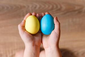 Paint eggs for Easter, bright Easter holiday, children paint eggs, colored eggs in a basket, colored eggs on a stand, Holiday background photo