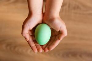 Paint eggs for Easter, bright Easter holiday, children paint eggs, colored eggs in a basket, colored eggs on a stand, Holiday background photo