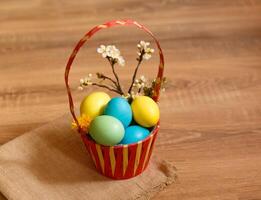 Paint eggs for Easter, bright Easter holiday, children paint eggs, colored eggs in a basket, colored eggs on a stand, Holiday background photo