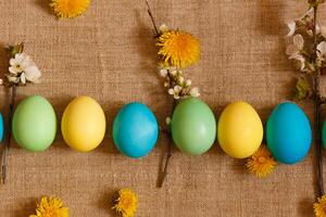 Paint eggs for Easter, bright Easter holiday, children paint eggs, colored eggs in a basket, colored eggs on a stand, Holiday background photo