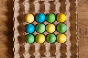 Paint eggs for Easter, bright Easter holiday, children paint eggs, colored eggs in a basket, colored eggs on a stand, Holiday background photo