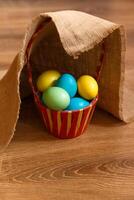 Paint eggs for Easter, bright Easter holiday, children paint eggs, colored eggs in a basket, colored eggs on a stand, Holiday background photo