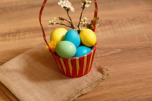 Paint eggs for Easter, bright Easter holiday, children paint eggs, colored eggs in a basket, colored eggs on a stand, Holiday background photo