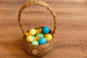 Paint eggs for Easter, bright Easter holiday, children paint eggs, colored eggs in a basket, colored eggs on a stand, Holiday background photo