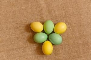 Paint eggs for Easter, bright Easter holiday, children paint eggs, colored eggs in a basket, colored eggs on a stand, Holiday background photo