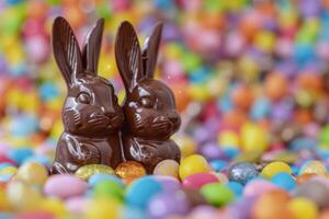 AI generated Chocolate Easter bunnies among colorful candy celebrate spring tradition photo