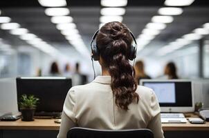 AI generated Back view of a person operating a laptop in an office photo