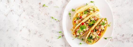 Mexican tacos with chicken meat, corn and salsa. Healthy tacos. Diet menu. Mexican taco. Top view, flat lay photo