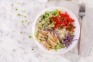 Fresh  salad  with grilled chicken breast, fillet and lettuce, daikon, red onions, cucumber and sesame. Healthy lunch menu. Diet food. Top view photo