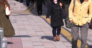 A crowd of walking people leg on the city street video