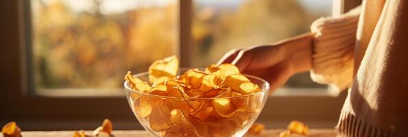 AI generated Young woman holding glass bowl of potato chips on blurred background with copy space. Banner photo