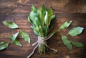 AI generated Fresh green leaves of bay tree on wooden background photo