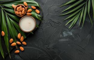 AI generated Almond milk in glass and almond nuts with palm leaf on black stone background photo