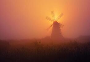 AI generated Windmill in the mist. A windmill rises from a misty field photo