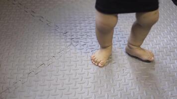 A little boy dances in the playroom. Stomping barefooted legs. video